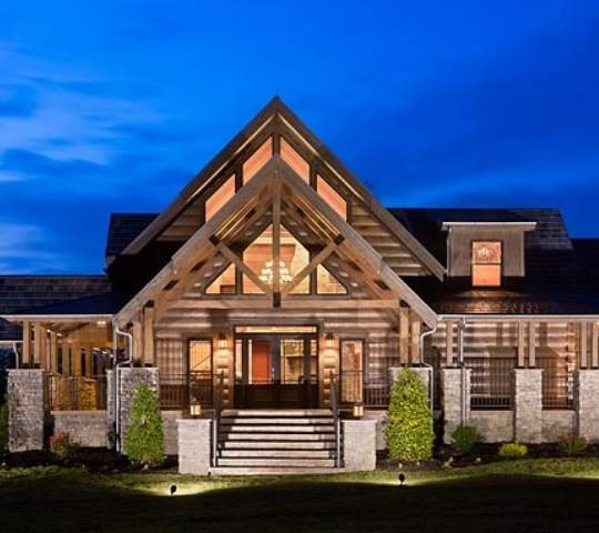 photo of entrance to timber frame log home with double a-frame covered porch entrance with exposed beams