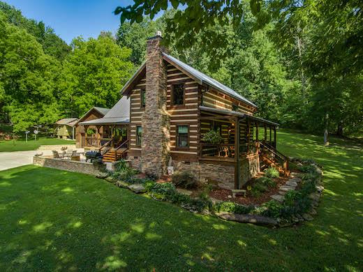 Photo of custom log home with expansive decks and towering fireplace