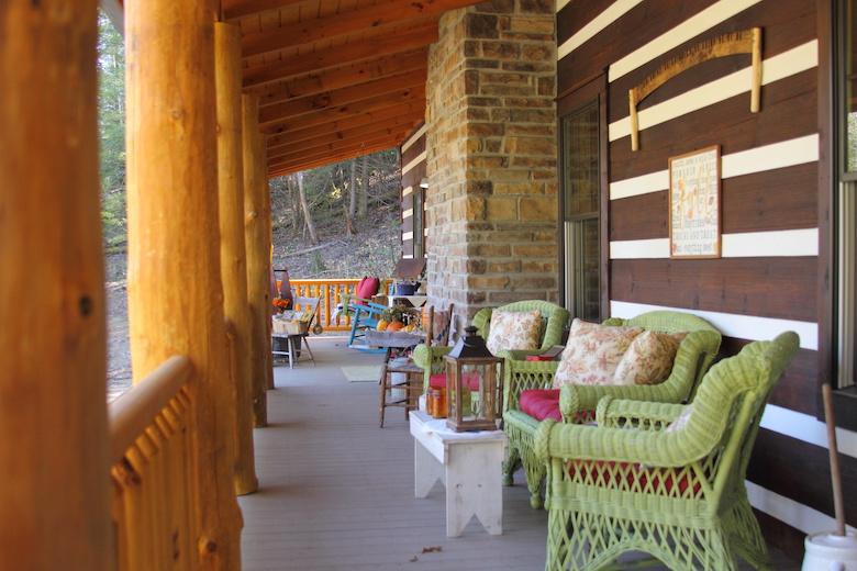 Photo of Log Cabin rustic porch with chink walls and large log railing