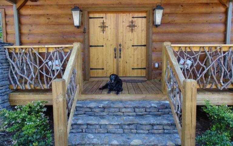 photo of entrance to a log home with stone entry steps